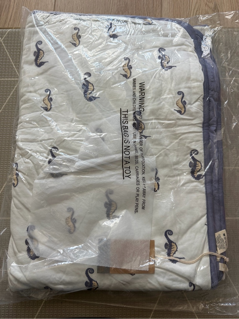 Kyte BABY White Quilted Baby Blanket with Navy Seahorse Print